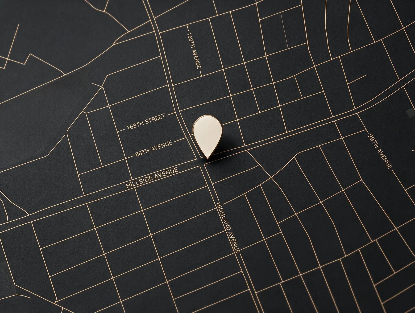 Stylized black-and-gold map of the Queens neighborhood around 168-06 Hillside Ave — Hillside Avenue, 168th Street and Highland Avenue — marked with a cream location pin