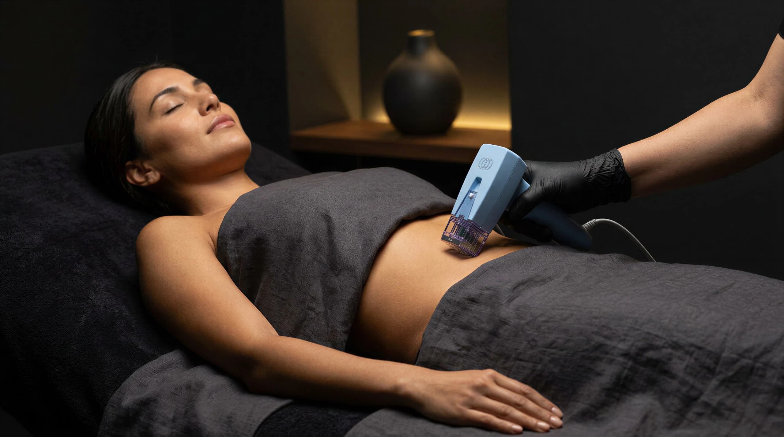 Body contouring applicator being used on a patient's abdomen during treatment